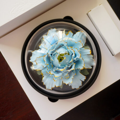 Blue ceramic flower diffuser with gold trim, blending art and function