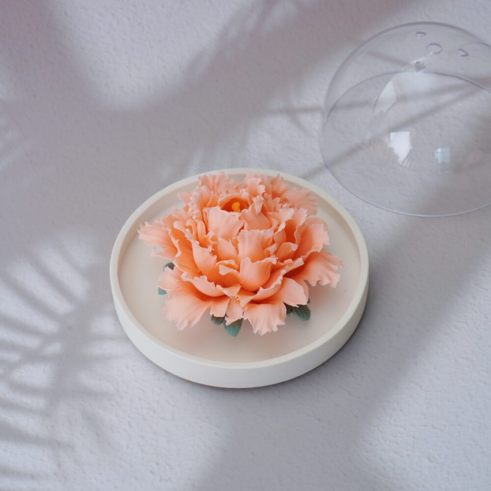 Handmade orange ceramic peony diffuser with acrylic cover for essential oil diffusion and incense holding.