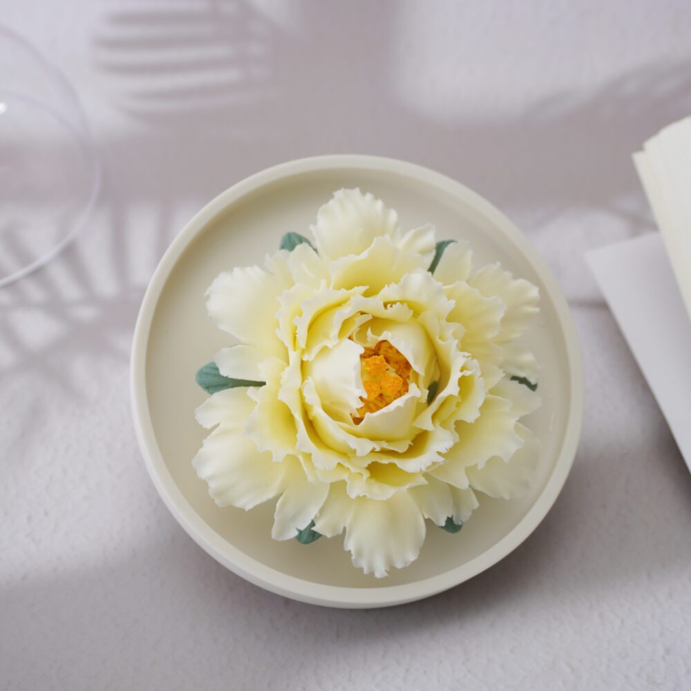 Handmade yellow ceramic peony diffuser with acrylic cover for essential oil diffusion and incense holding.